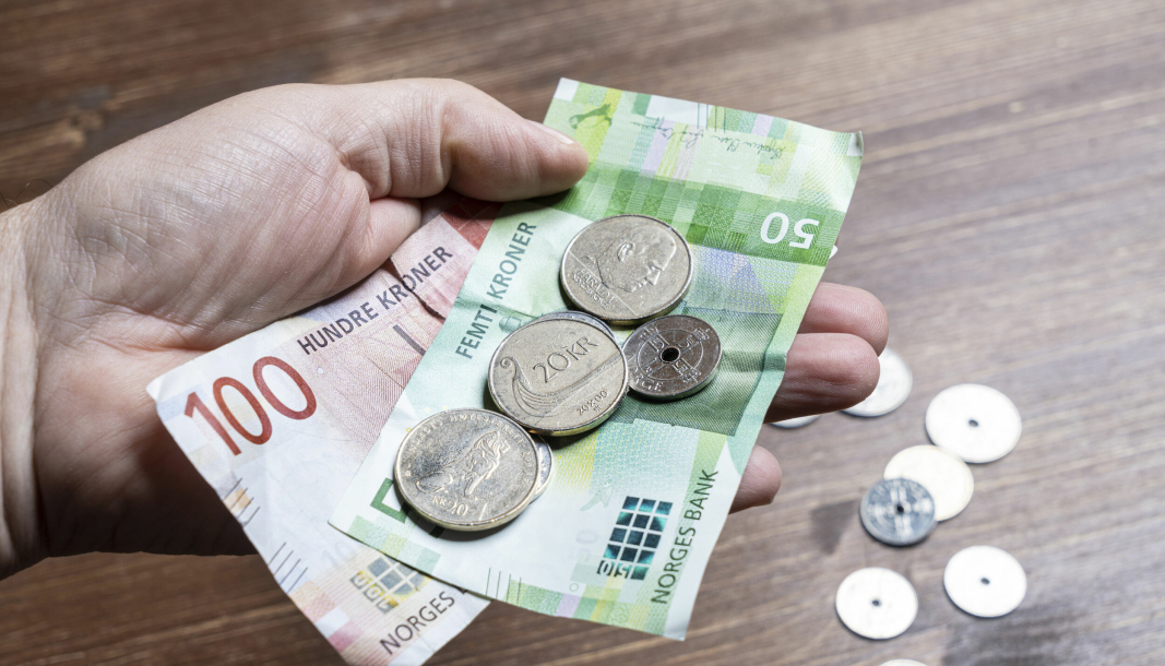 Oslo, Norway. September 2021. some Norwegian kroner bills and coins in the hand