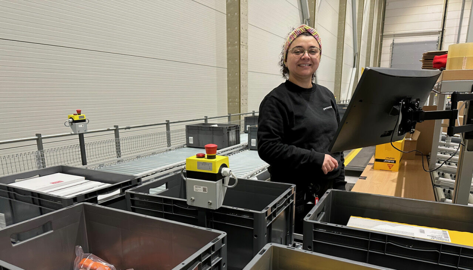 Alison Taibo i arbeid ved plukkstasjon ved Optimeras sentrallager som håndterer både paller og miniload-kasser.